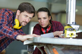 concentrated woman and man during apprenticeship