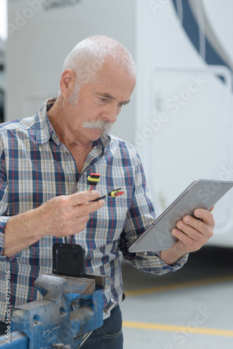 senior engineer using a tablet computer in a factory