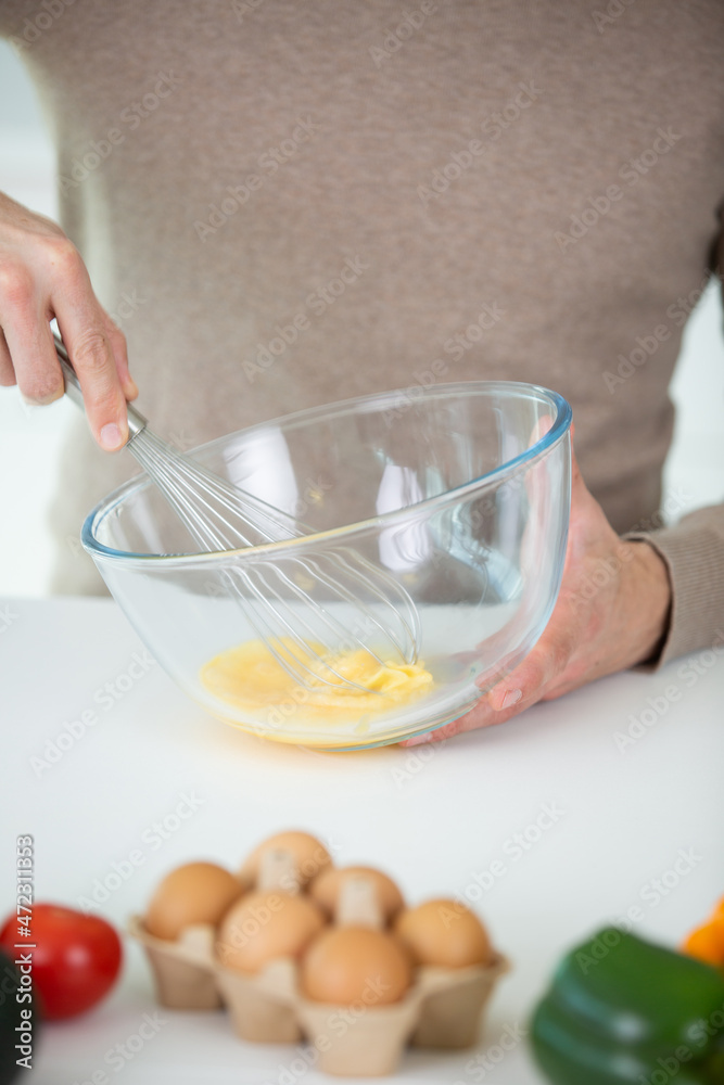 woman whisking eggs for christmas cookies