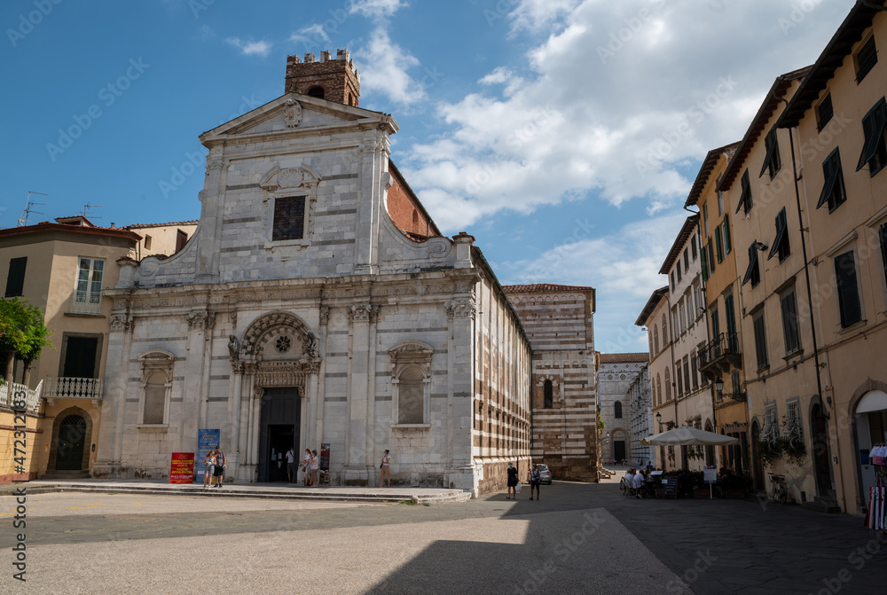 Lucca, Tuscany, Italy. August 2020. The facade of the church of Santi Giovanni e Reparata on a beautiful sunny day. People in the square.