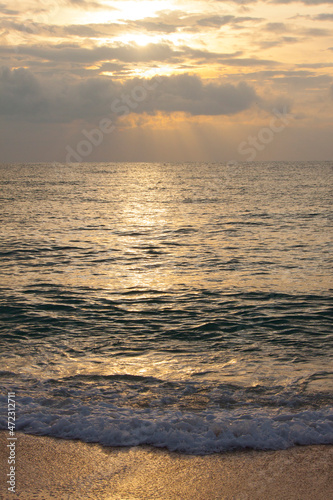 Thailand  Ko Samui. Light surf hitting the beach the beach at sunset.