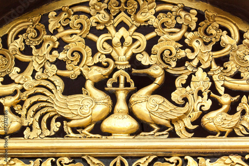 Thailand, Ko Samui. Temple detail. Gilded carving with animals and birds.