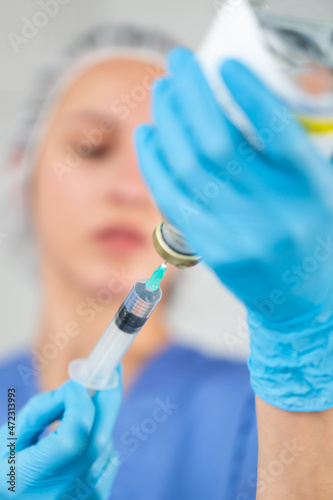 Portrait of a nurse with a syringe preparing for vaccination