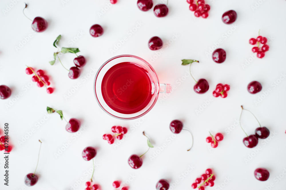 Glass cup of fruit tea on white backgrund with red berries. Glass cup of fruit tea on white backgrund with red berries.