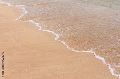 wave and sand on the beach