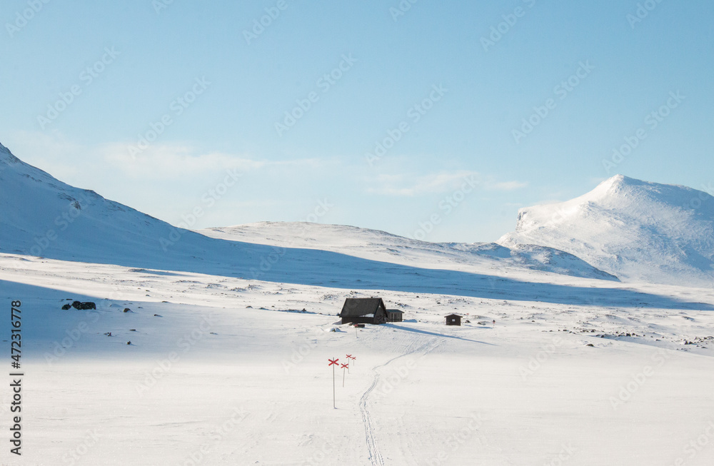 An emergency hut along Kungsleden trail between Salka and Kebnekaise covered in snow, early April 2021