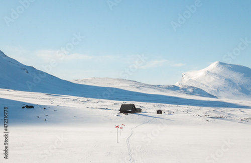 An emergency hut along Kungsleden trail between Salka and Kebnekaise covered in snow, early April 2021 photo
