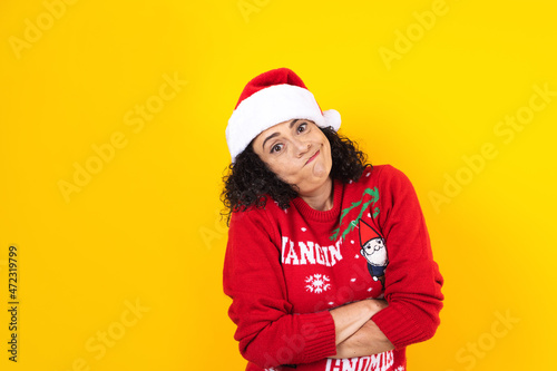 hispanic adult woman portrait with expression face in winter sweater on yellow background in Mexico Latin America