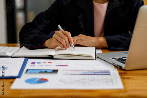 Wallpaper Mural Businesswoman working at office with documents on his desk, doing planning analyzing the financial report, business plan investment, finance analysis concept Torontodigital.ca