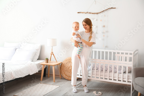 Young mother holding her cu...