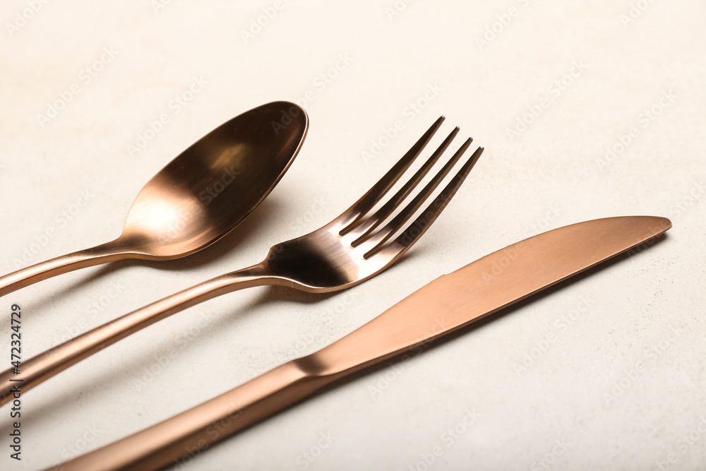 Stylish cutlery on light table background Stylish cutlery on light table background