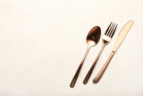 Stylish cutlery on light table background