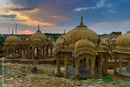 Bada Bagh or Barabagh, means Big Garden,is a garden complex in Jaisalmer, Rajasthan, India, for Royal cenotaphs of Maharajas or Kings of Jaisalmer state. Tourist attraction. Setting sun in background.