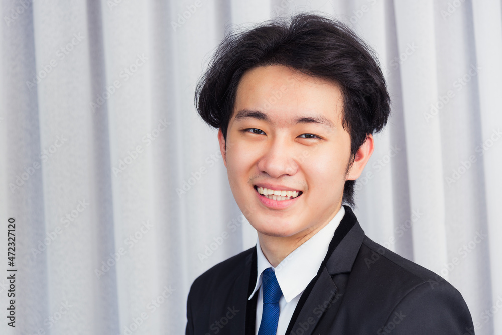 Portrait closeup of happy Asian young handsome manager professional business man laughing confident mature standing in suit smiling looking to camera with copy space Portrait closeup of happy Asian young handsome manager professional business man laughing confident mature standing in suit smiling looking to camera with copy space