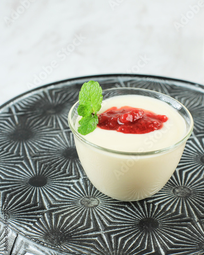 Strawberry Panna Cotta on Mini Bowl, Italian Traditional Dessert with Jelly and Strawberry Compote, Topped with Mint Leaf photo