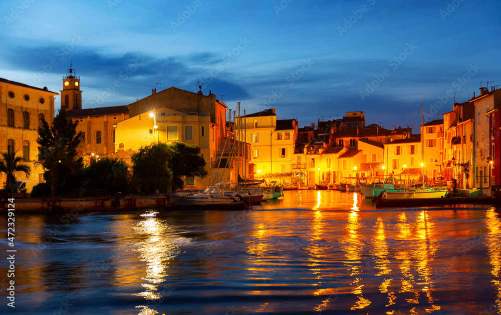Picturesque streets with backlit village of Martigues at night. France