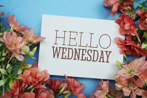 Hello Wednesday text with Pink Flower frame on blue background