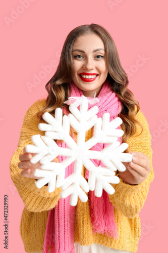 Happy woman with big snowfl...