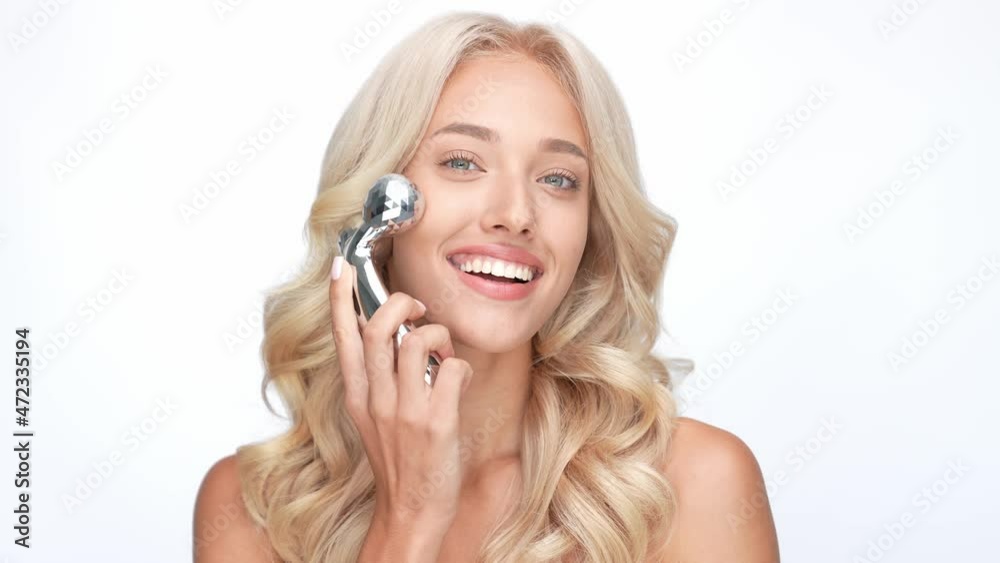 Cute lady use silver product massage body isolated white color background Cute lady use silver product massage body isolated white color background