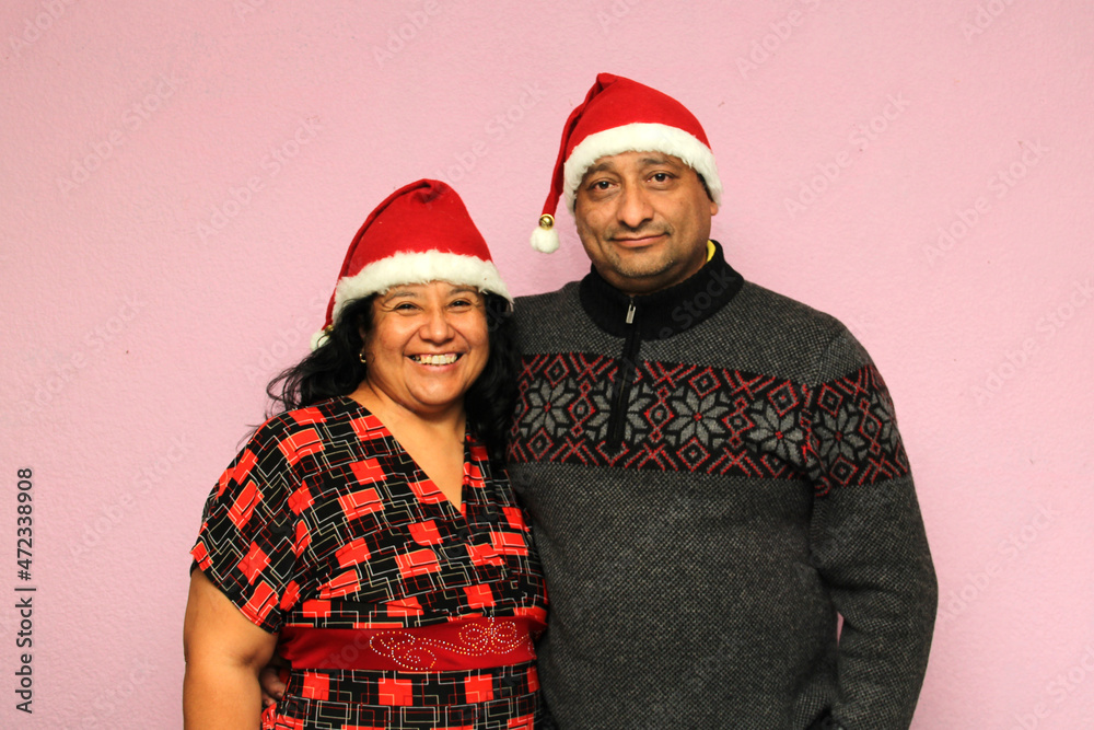 Latino couple with overweight body positive wearing santa hats are happy and excited about the arrival of December and celebrating Christmas as a family
Latino couple with overweight body positive wearing santa hats are happy and excited about the arrival of December and celebrating Christmas as a family