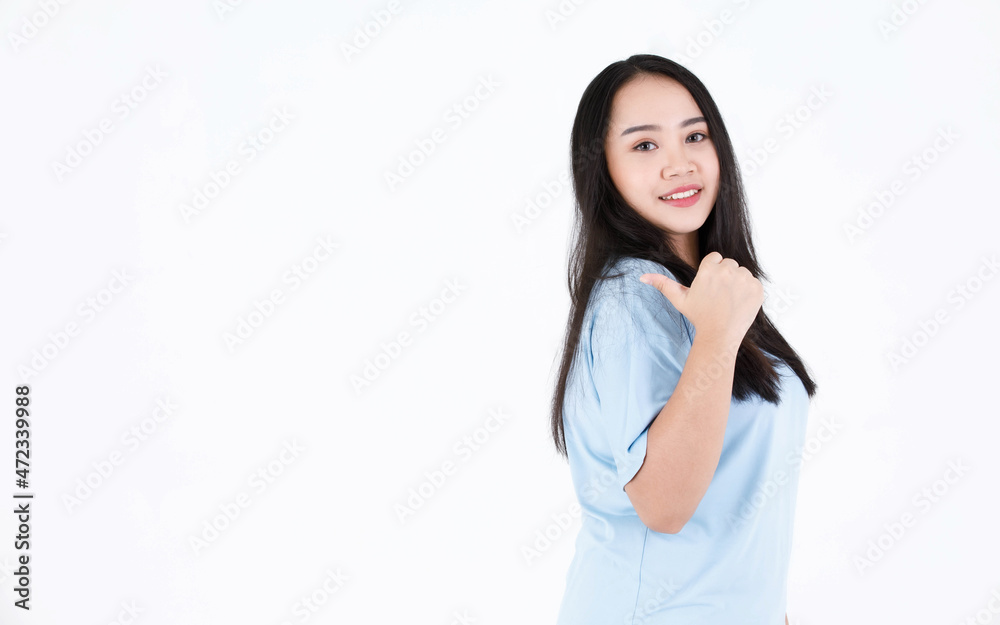 Portrait studio shot of Asian young chubby plump long black hair female model in blue casual t shirt and pose and in advetise action showing presenting product on white background Portrait studio shot of Asian young chubby plump long black hair female model in blue casual t shirt and pose and in advetise action showing presenting product on white background