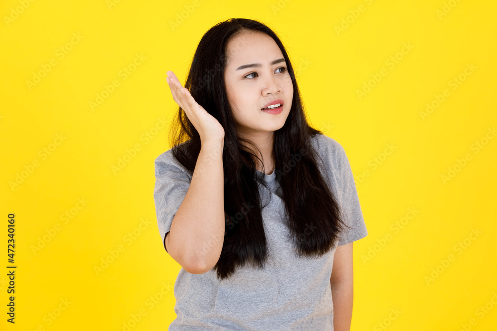 Portrait studio shot of Asian young beautiful chubby plump long black hair female model in casual outfit standing holding crossed hands sign saying no reject refuse deny decline on yellow background Portrait studio shot of Asian young beautiful chubby plump long black hair female model in casual outfit standing holding crossed hands sign saying no reject refuse deny decline on yellow background