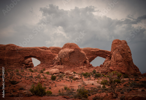 View of North and South Windows Arch  storm clouds in the sky  Arches National Park  Utah  USA
