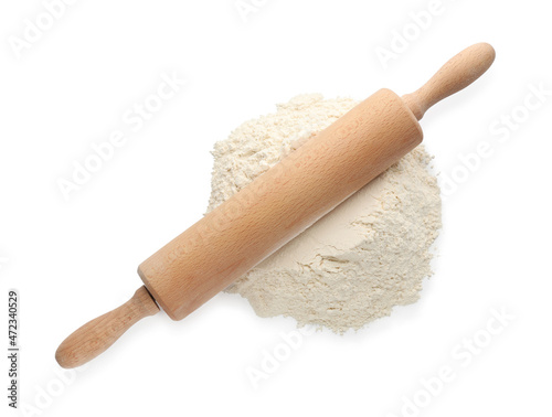 Wooden rolling pin and flour on white background, top view