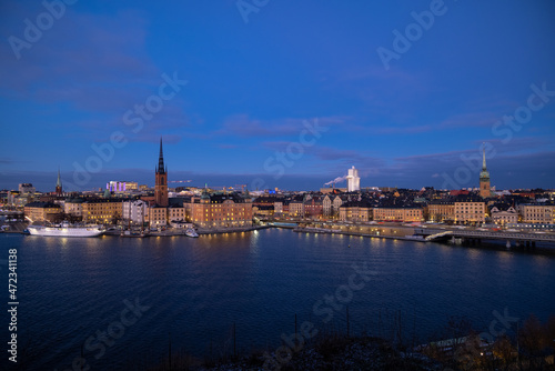 Beautiful panorama of Stockholm at night with sea, buildings, boats and night city lights. Capital of Sweden photographed from the hill.  © boumenjapet