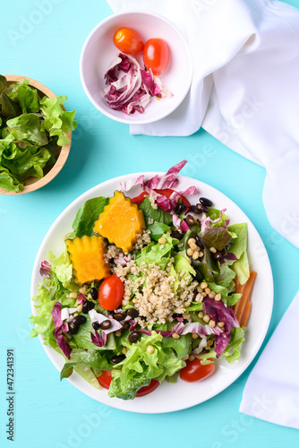 Fresh organic vegetables with quinoa salad on color background, Healthy Vegan food, Top view