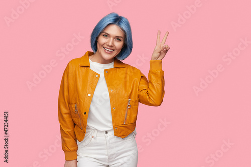 Cheerful woman showing v sign