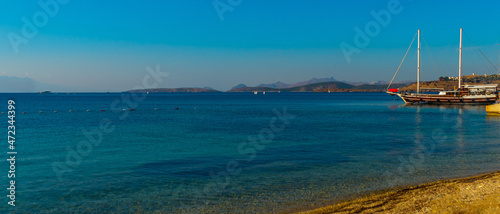 BODRUM, TURKEY: Beautiful seascape with a view of the ship and the mountains on the horizon in Bodrum on a sunny day.