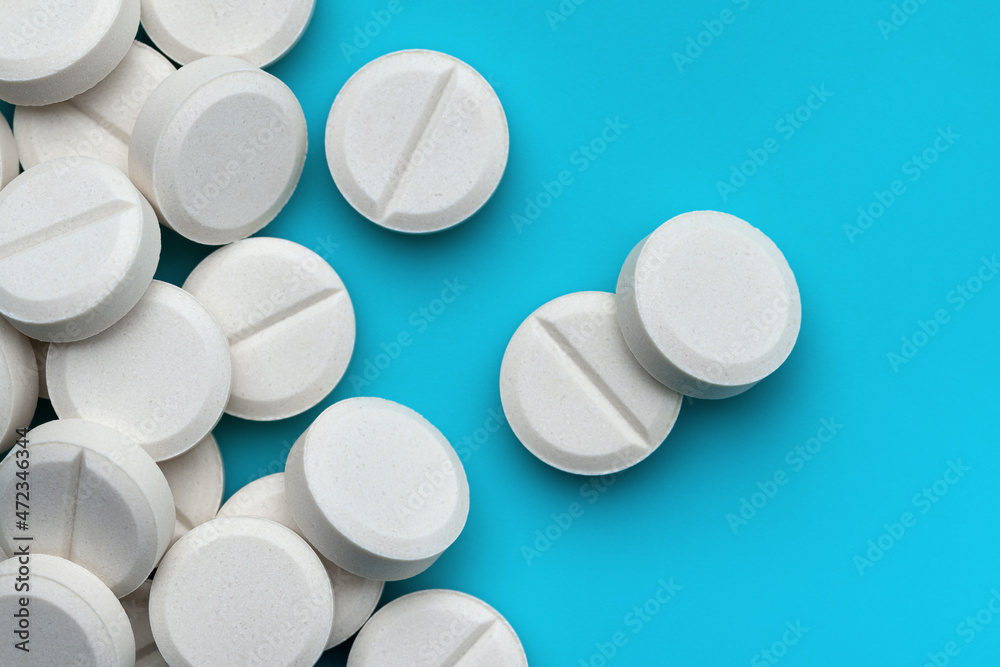 Pharmacy. Medicines sample white medical pills. Blue background, copy space