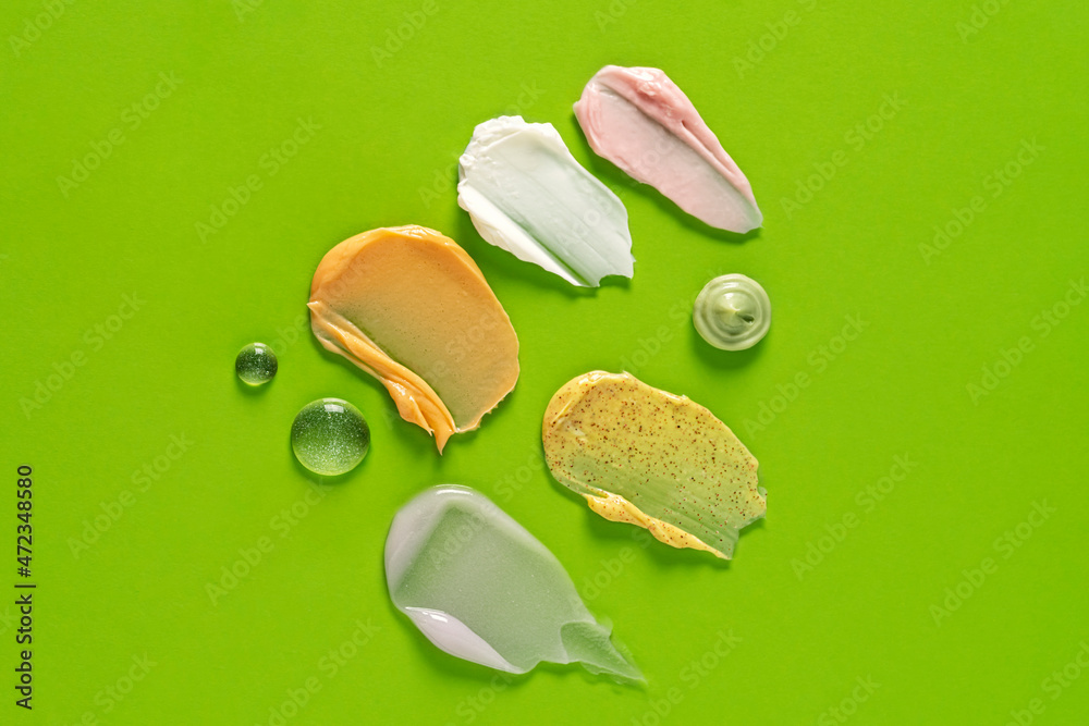 Different cosmetic smears on a green background. Different cosmetic smears on a green background.