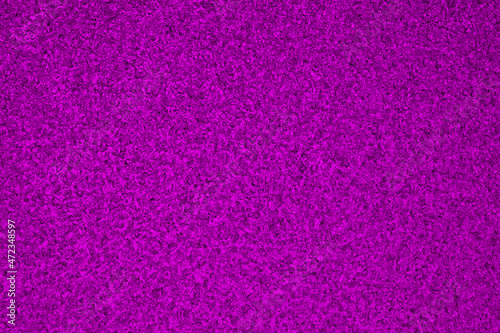 Deep violet winter background. Rich saturated bright color. Dark purple tinted wallpaper. Ice crystals surface on window glass close-up. A pattern of chaotic spots
