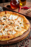 Fresh cooked pizza with chicken and sour cream sauce