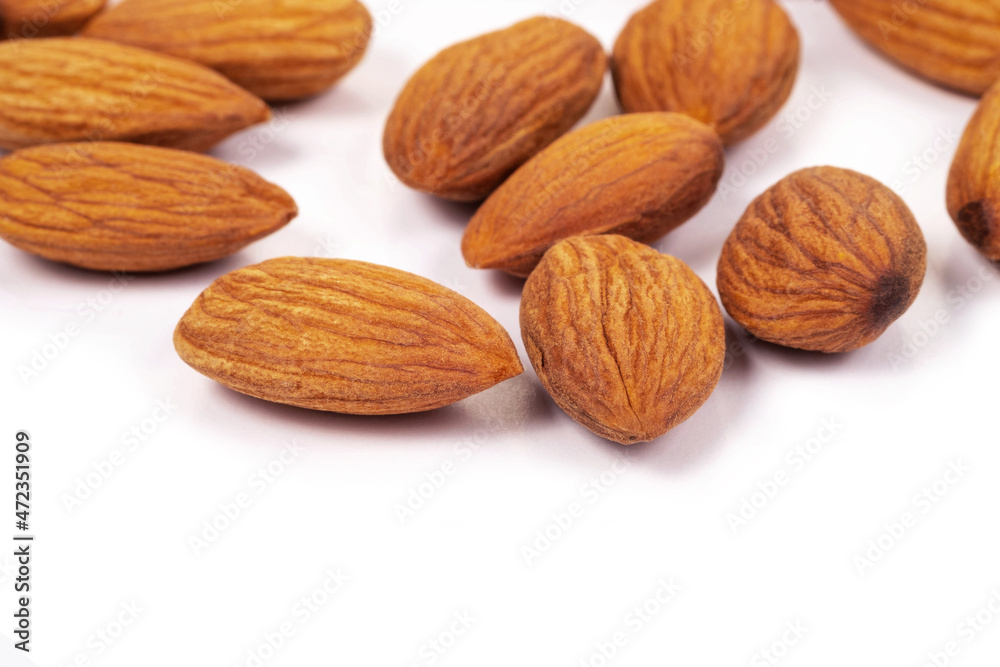 Close up organic almonds on white background. Health food concept. Close up organic almonds on white background. Health food concept.
