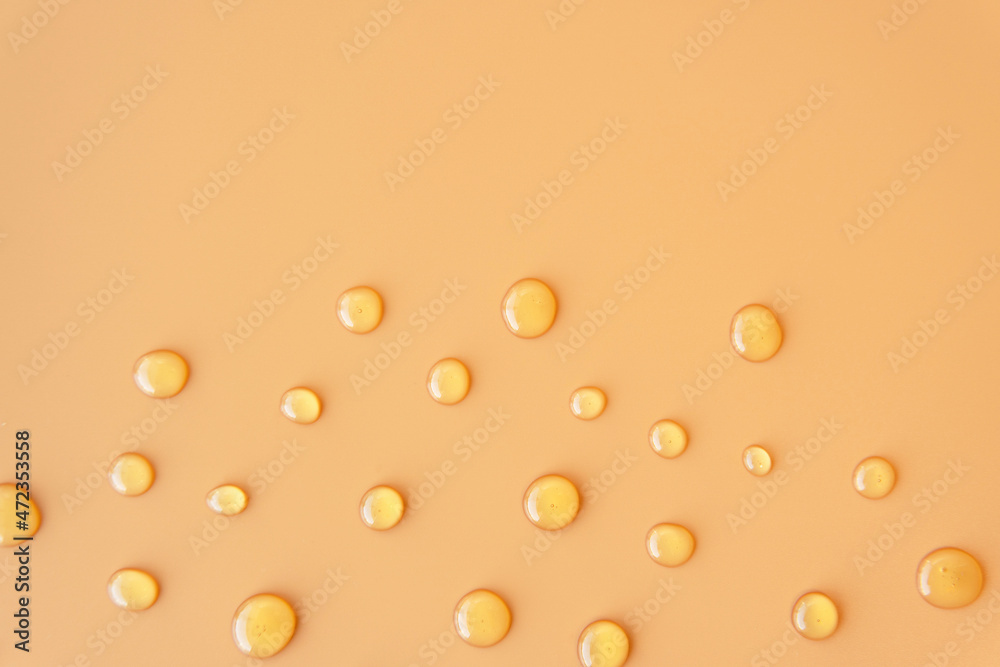 Flatlay top view sweet Honey texture drop round shape on plain light orange yellow color background. Skincare ingredient for antibacterial and suitable for acne prone oily sensitive or all skin types Flatlay top view sweet Honey texture drop round shape on plain light orange yellow color background. Skincare ingredient for antibacterial and suitable for acne prone oily sensitive or all skin types