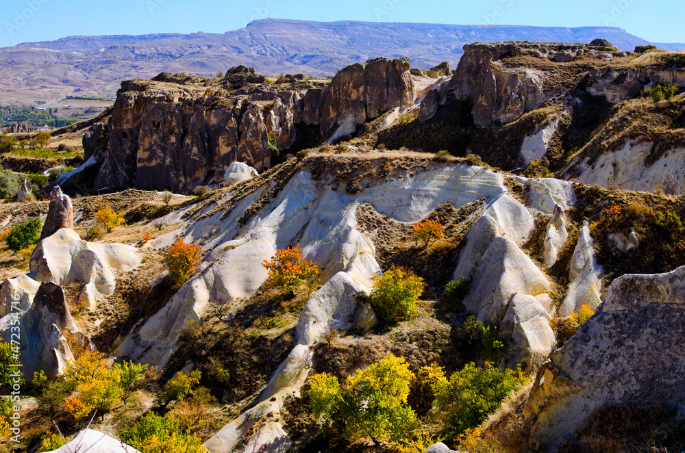 Astonishing landscape view of geologic formations of Cappadocia. Amazing shaped sandstone rocks. Famous touristic place and romantic travel destination. Picturesque autumn view Astonishing landscape view of geologic formations of Cappadocia. Amazing shaped sandstone rocks. Famous touristic place and romantic travel destination. Picturesque autumn view