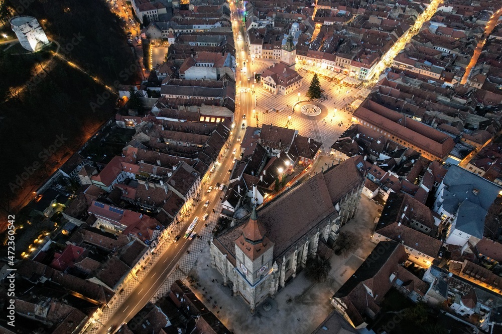 Aerial night view of the old town area of the city of Brasov, with a well-preserved medieval center. Transylvania, Romania