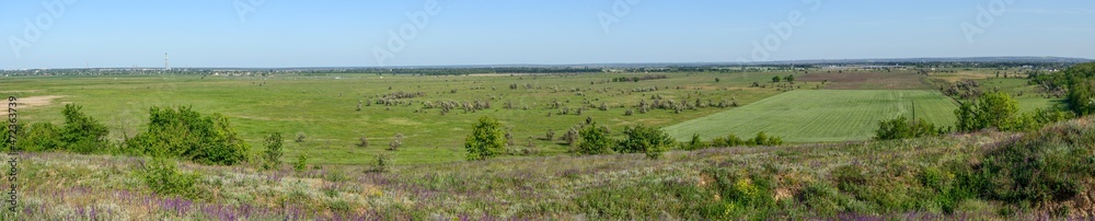 Panoramic landscape of rural plain in spring sunlight, Dnepr, Ukraine.