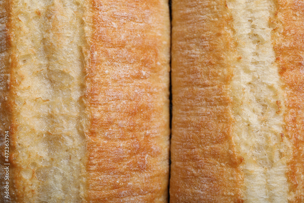 Tasty baguettes as background, top view. Fresh bread