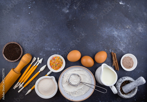 baking cooking ingredients, flour, eggs, milk, sugar and kitchen utensils 
