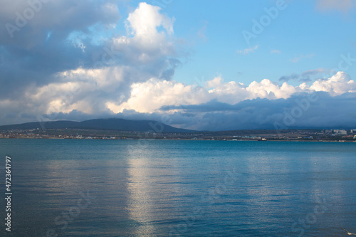 A blue cloud with a white cloud is reflected in the sea