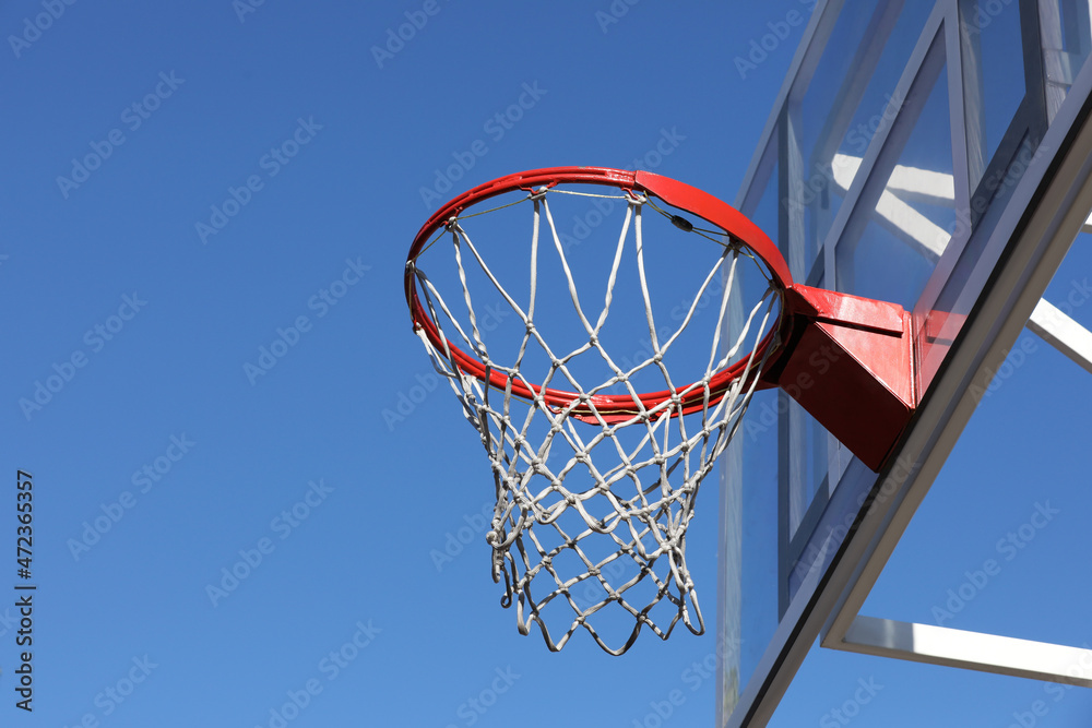 Basketball hoop with net outdoors on sunny day, space for text
