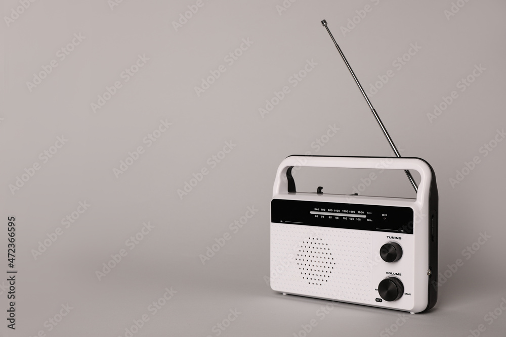 Portable retro radio receiver on grey background. Space for text Portable retro radio receiver on grey background. Space for text
