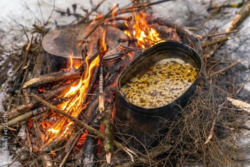 Cooking food on a campfire in the woods in nature