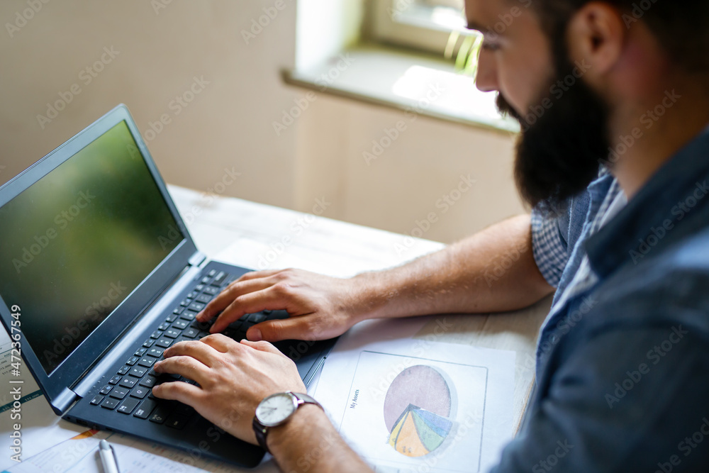 Successful businessman working in the office analyzing business data on notebook Successful businessman working in the office analyzing business data on notebook