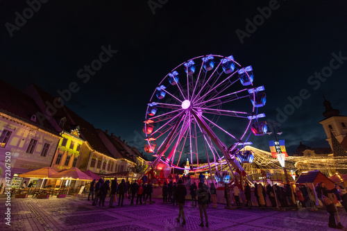 Colored Ferris Wheel at Christmas Market on a calm night