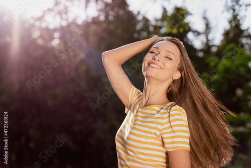 Portrait of attractive carefree cheerful dreamy peaceful girl spending holiday free time posing breathing fresh air outdoors